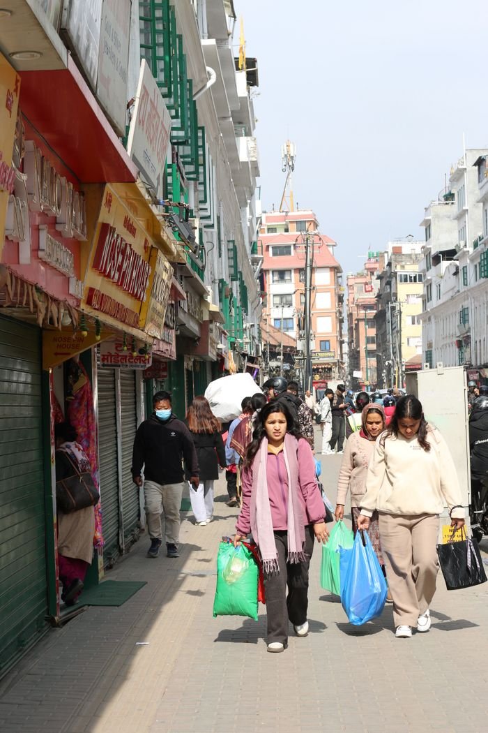 A bustling street scene of shoppers in Kathmandu, Nepal, showcasing vibrant city life.